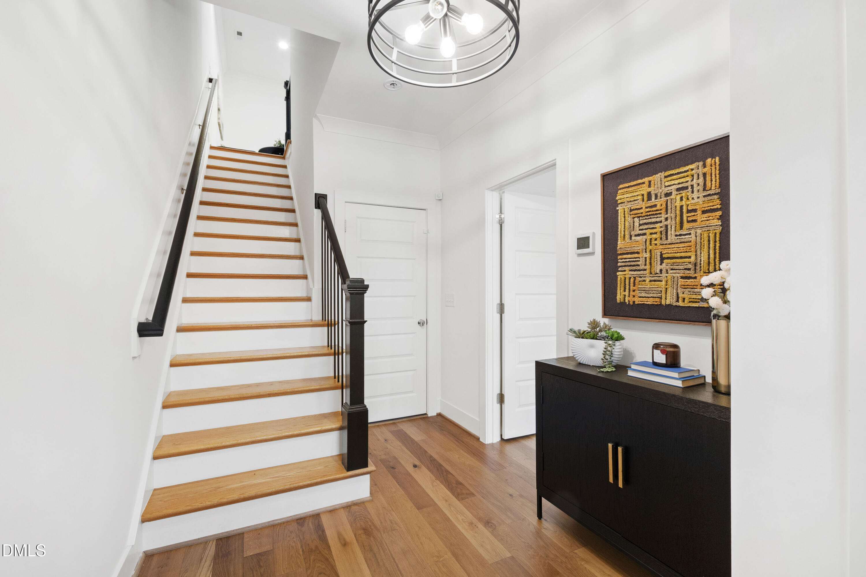 718 Peakland Place Raleigh, NC 27604 - Photo 9 of 48 a view of a hallway with wooden floor and workspace
