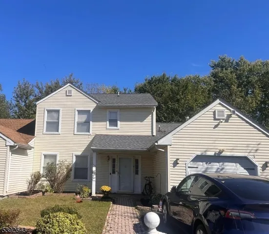 a view of a white house with a yard