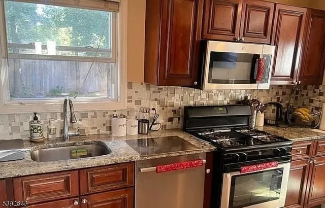 a kitchen with a sink and a stove top oven
