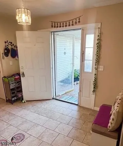 a view of a livingroom with furniture and a hallway