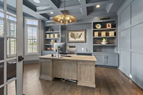 a kitchen with stainless steel appliances a stove a sink dishwasher and a dining table with wooden floor