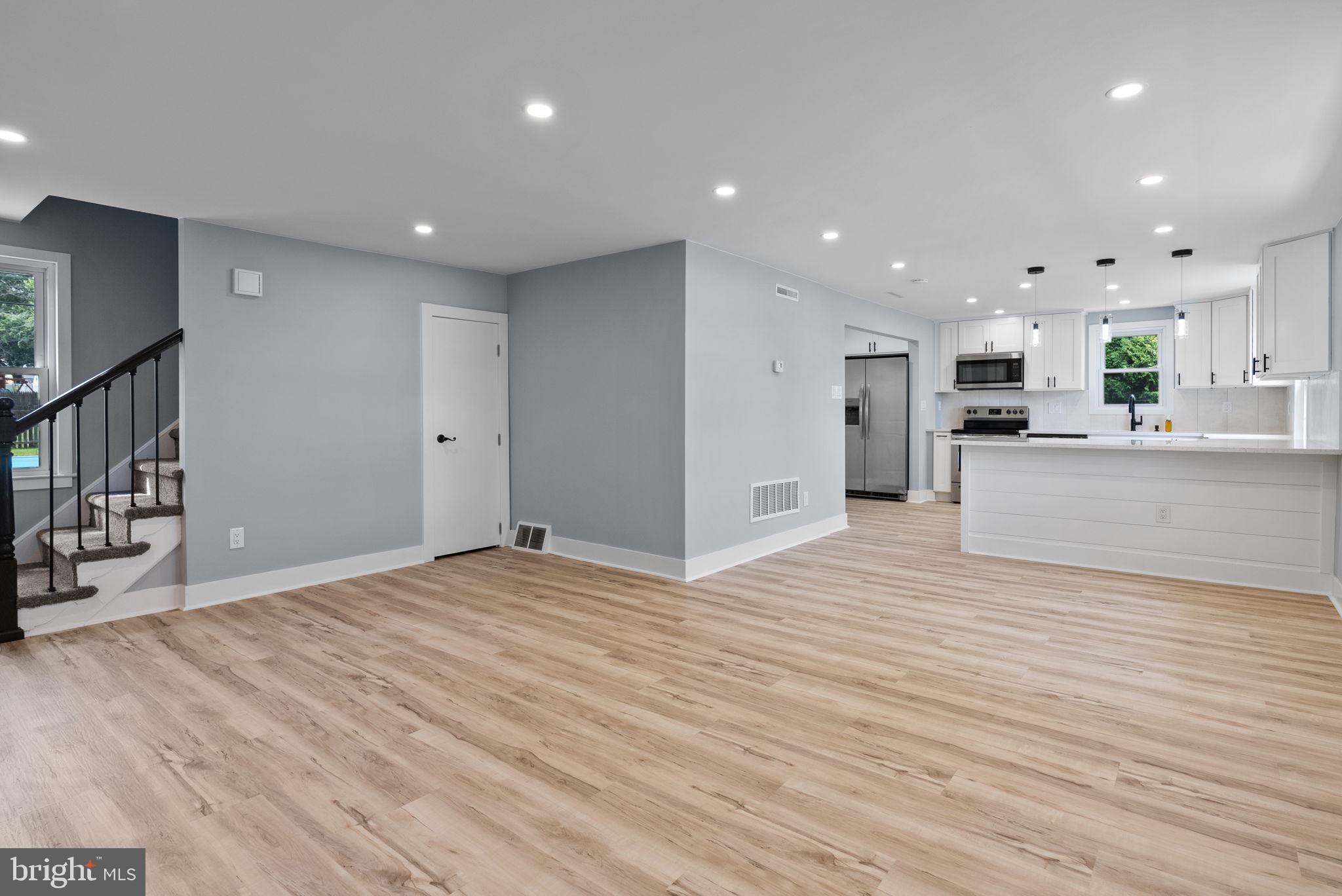 160 Church Road North Wales, PA 19454 - Photo 11 of 36 a view of a kitchen with kitchen island granite countertop wooden floor stainless steel appliances and cabinets