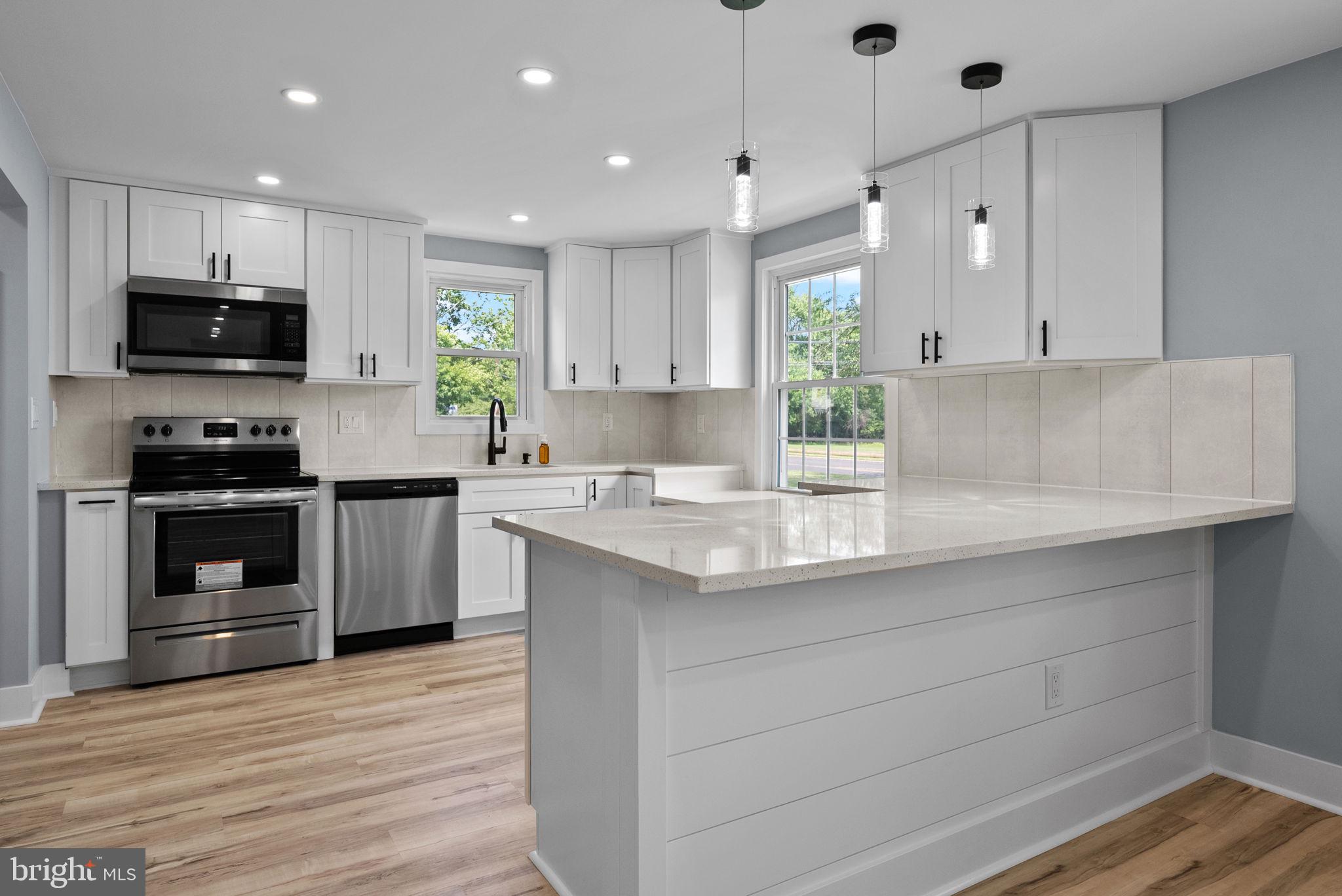 160 Church Road North Wales, PA 19454 - Photo 14 of 36 a kitchen with stainless steel appliances granite countertop a sink a stove and cabinets