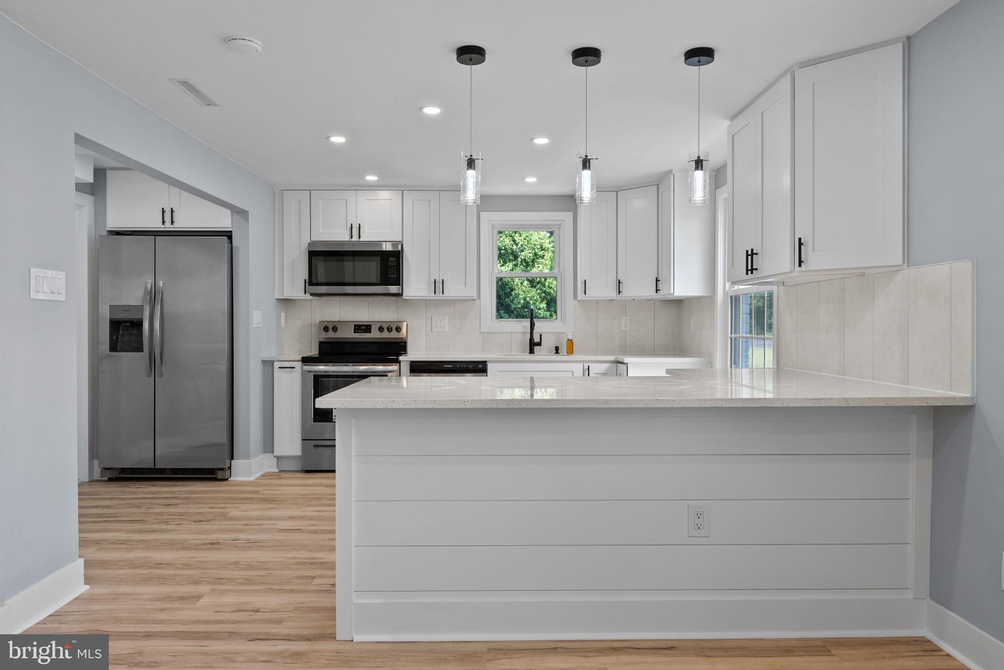 160 Church Road North Wales, PA 19454 - Photo 15 of 36 a kitchen with stainless steel appliances kitchen island granite countertop a refrigerator and a stove