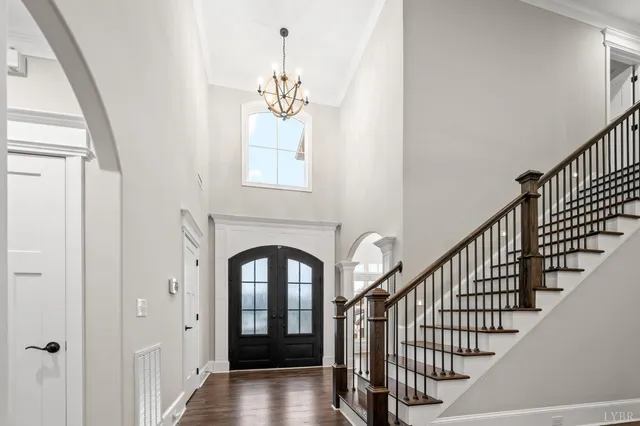 a kitchen with kitchen island a dining table chairs stainless steel appliances and cabinets