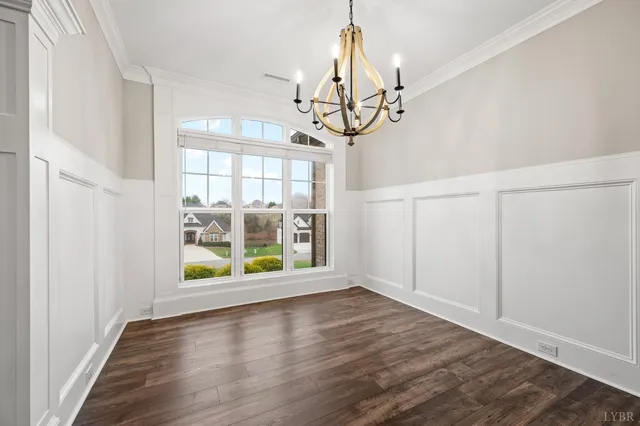 a room with wooden floor pool table and chairs