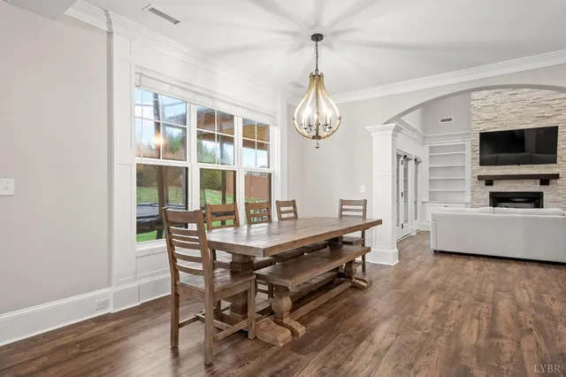 a bedroom with a bed a chandelier and a dresser