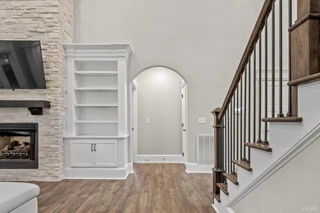 an aerial view of a house with a garden and lake view