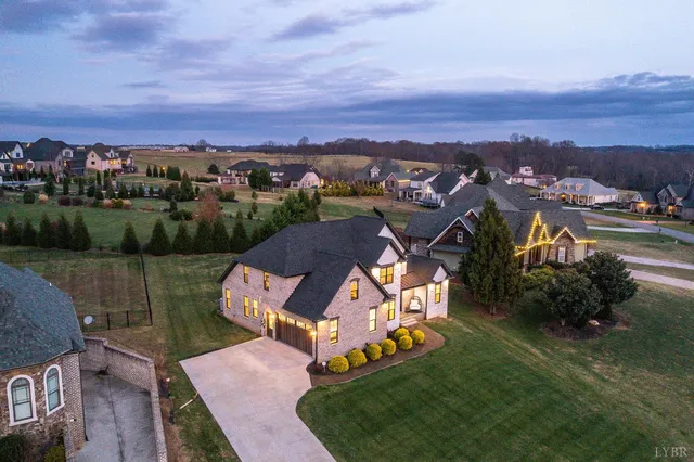 an aerial view of residential houses with outdoor space and city view