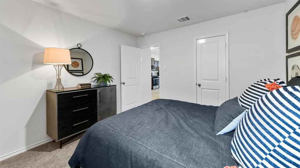 1671 Mantle Road Crandall, TX 75114 - Photo 21 of 24 Carpeted room with white walls and a white door featuring a brushed nickel knob