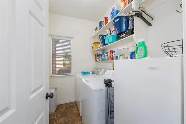 a bathroom with a toilet sink mirror and vanity