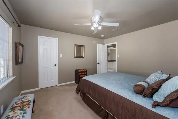 a bathroom with a granite countertop double vanity and a mirror