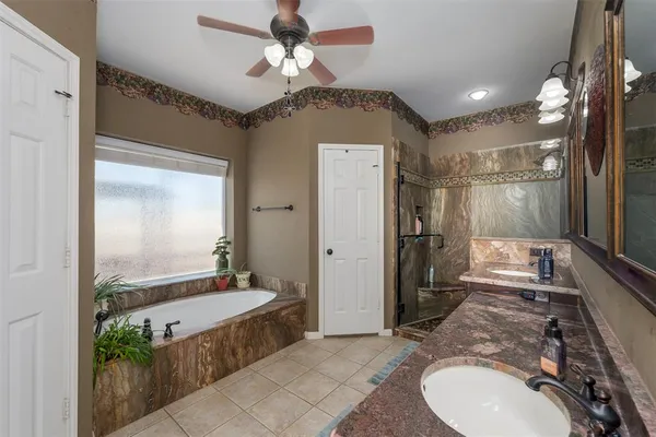 a bedroom with a bed and ceiling fan