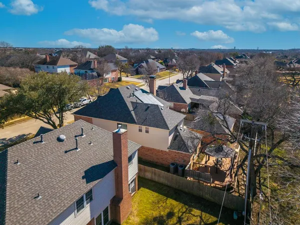 an aerial view of residential houses with outdoor space