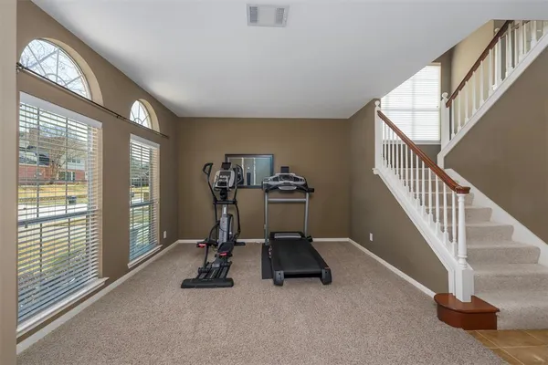 a view of a livingroom with gym equipment