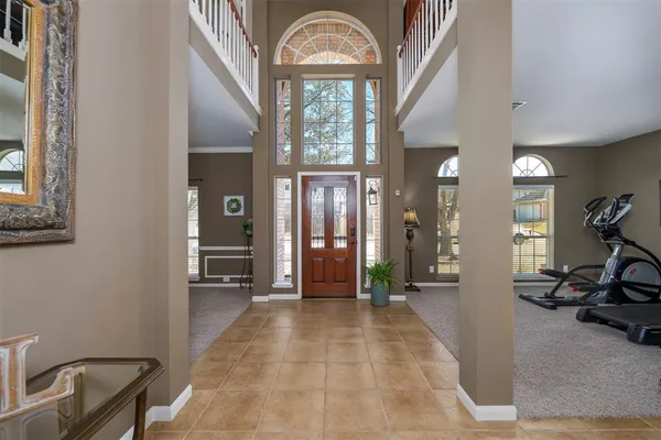 a view of a hallway with furniture and a chandelier