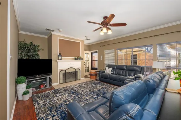 a living room with furniture a flat screen tv and a fireplace