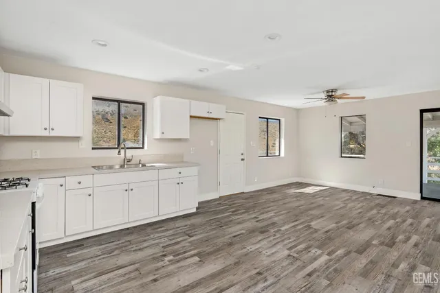 a view of a kitchen with granite countertop cabinets and wooden floor