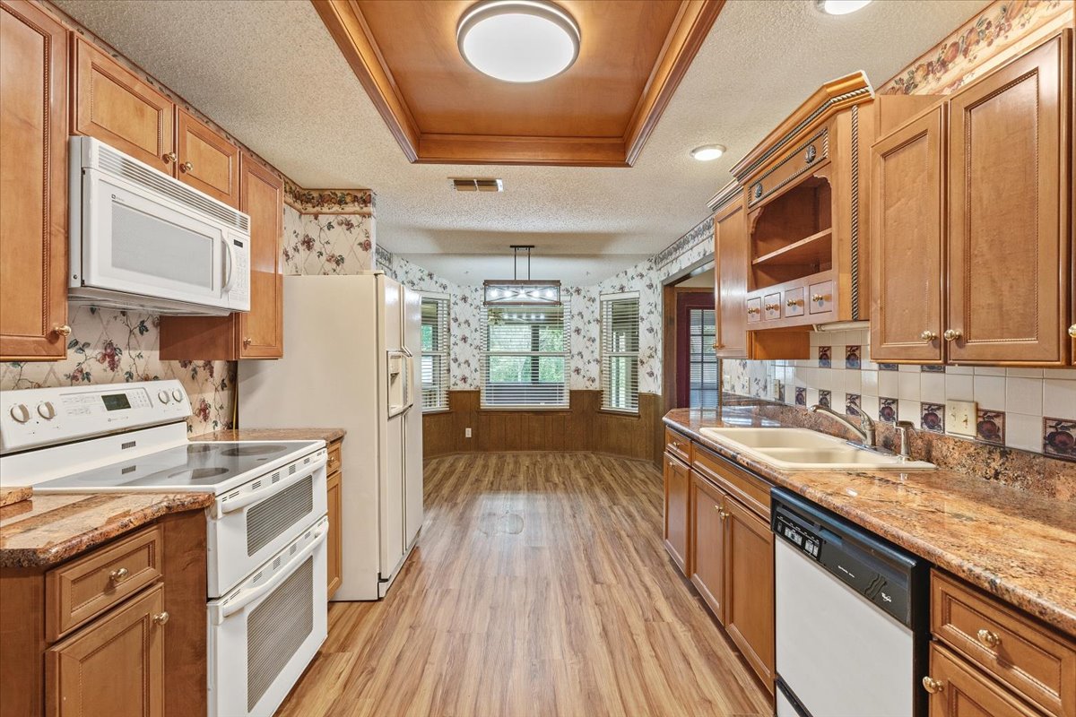 250 Hickory Drive Elgin, TX 78621 - Photo 12 of 37 a view of a kitchen with a sink and wooden floor