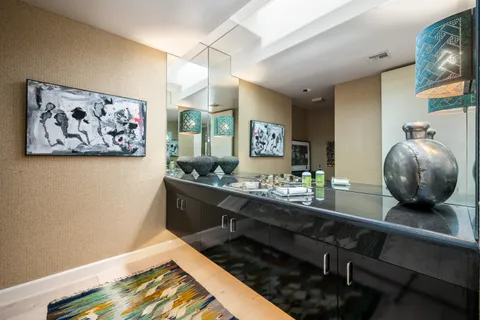 a kitchen with a table chairs and wooden floor