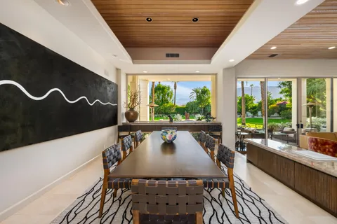 a view of a dining room with furniture and window