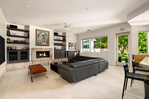 a view of a house with backyard sitting area and garden