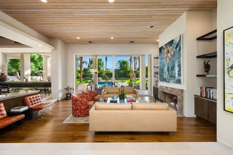 a room with furniture and wall paintings