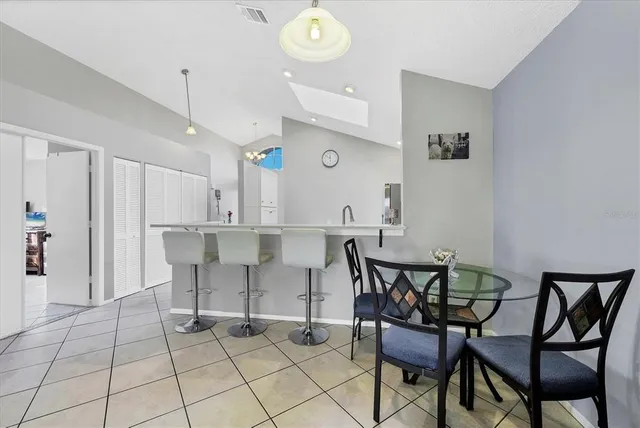 a view of kitchen and dining area with a table