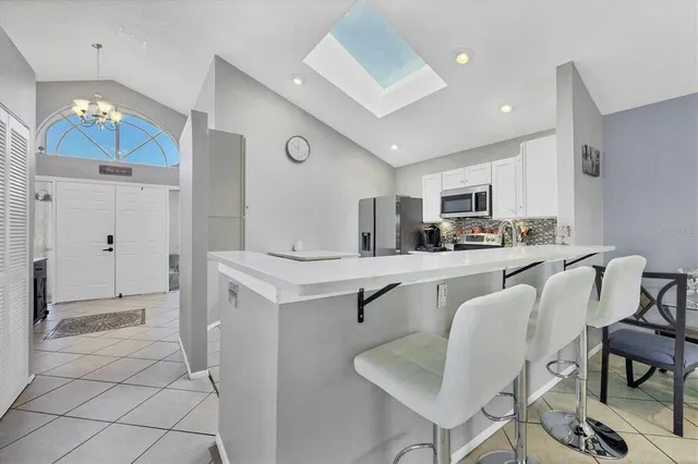 a kitchen with stainless steel appliances kitchen island granite countertop a sink and cabinets