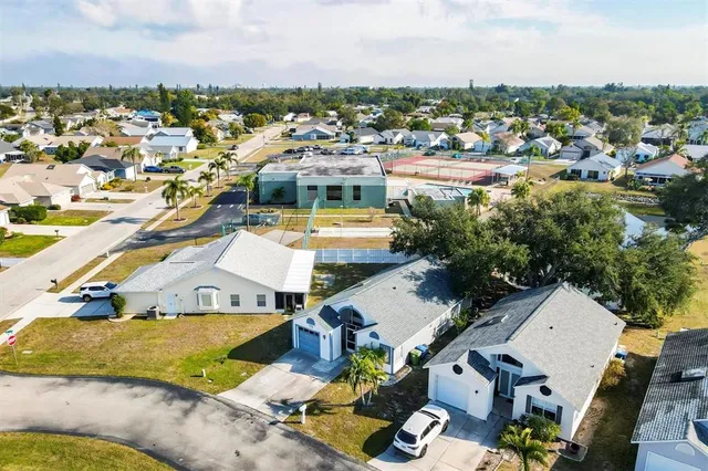 an aerial view of a house with a swimming pool yard and outdoor seating