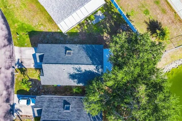 an aerial view of a house with a yard
