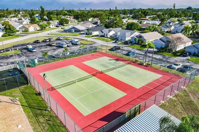 a view of a tennis ground with a street