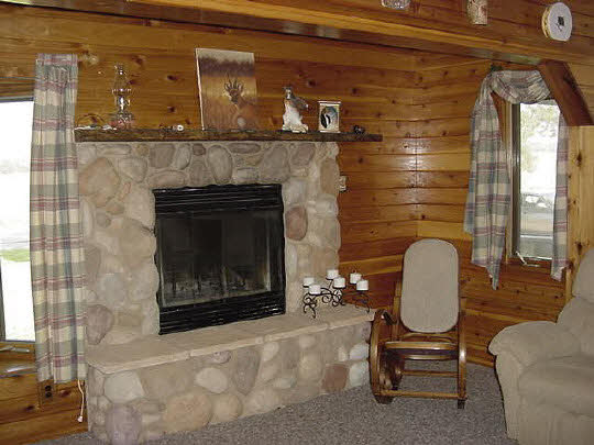 11114 Harrison Road Rockton, IL 61072 - Photo 4 of 5 a living room with furniture and a fireplace