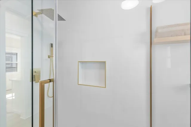 a bathroom with a bathtub and shower