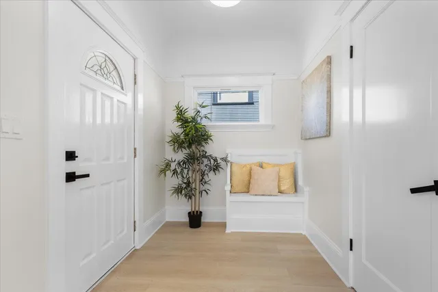 a view of entryway with paintings on the wall