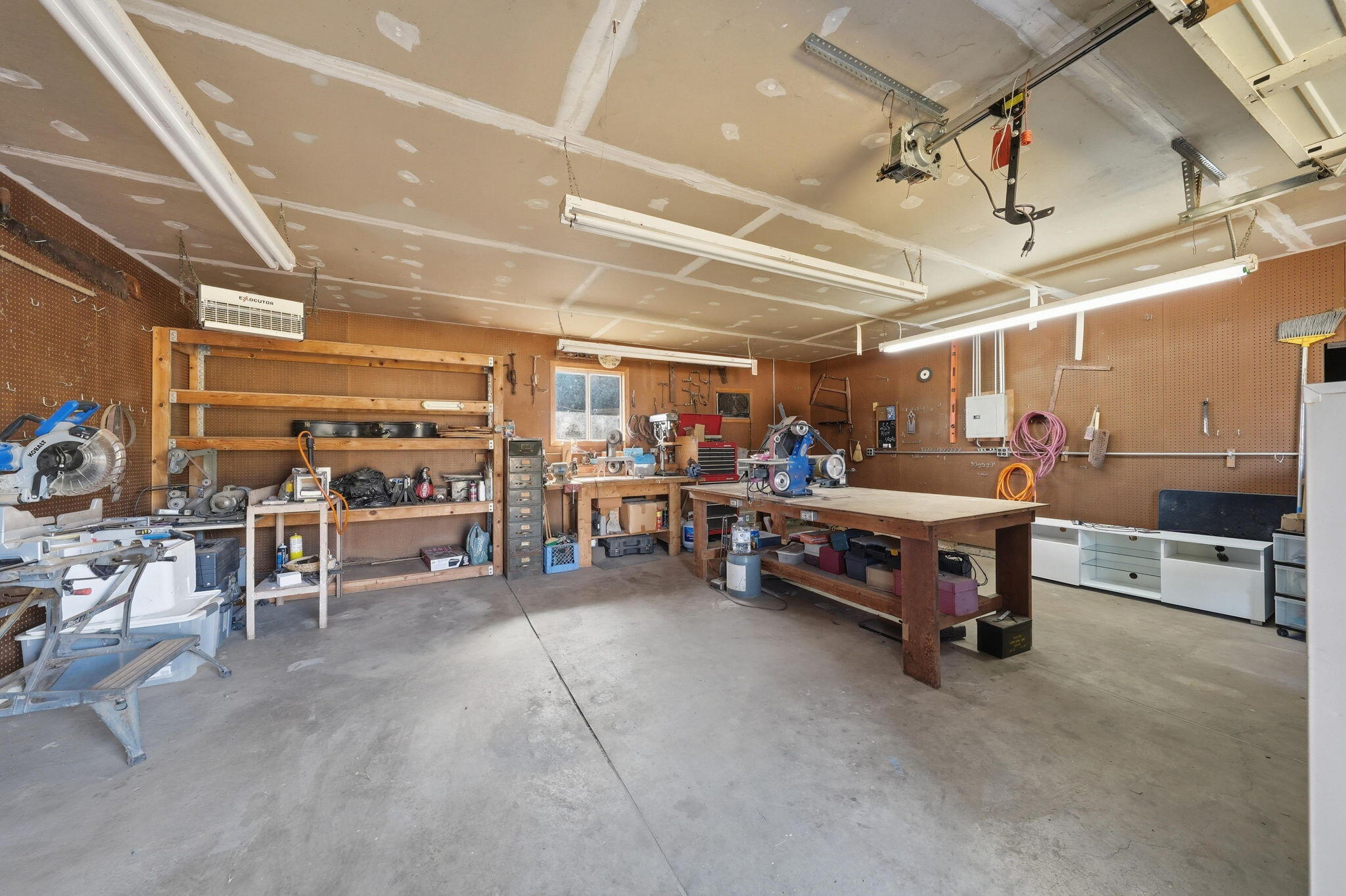 22189 Old Alturas Road Redding, CA 96003 - Photo 32 of 70 a garage with furniture and a ceiling fan
