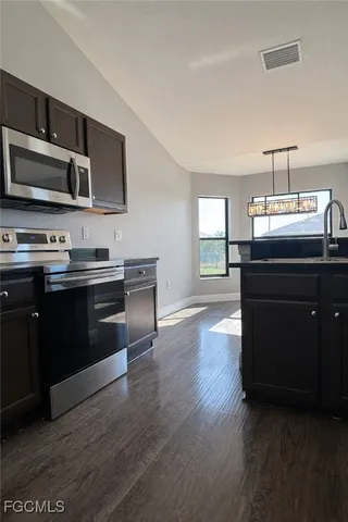 a kitchen with metallic refrigerator freezer and a dishwasher