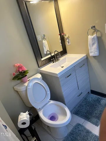 a bathroom with a toilet mirror and sink