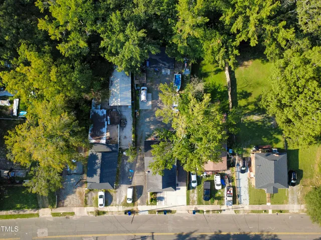 a front view of a house with a yard and tree s