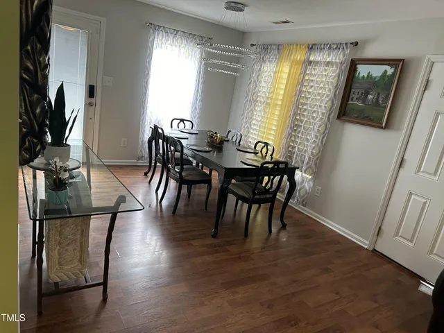 a view of a dining room with furniture and a window