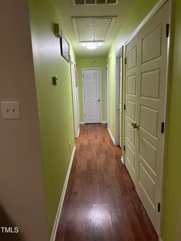 a view of hallway with wooden floor