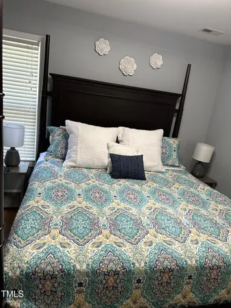 a bedroom with a bed and window