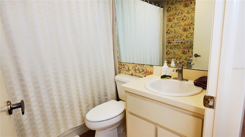 603 Baldwin Avenue, Unit B Safety Harbor, FL 34695 - Photo 10 of 32 a bathroom with a sink and a toilet