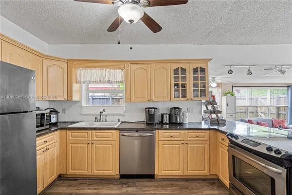 a kitchen with a sink stove and microwave