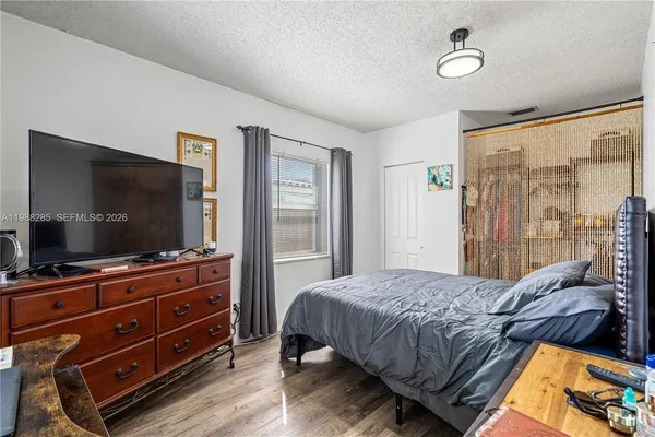 a bedroom with a bed and a flat screen tv