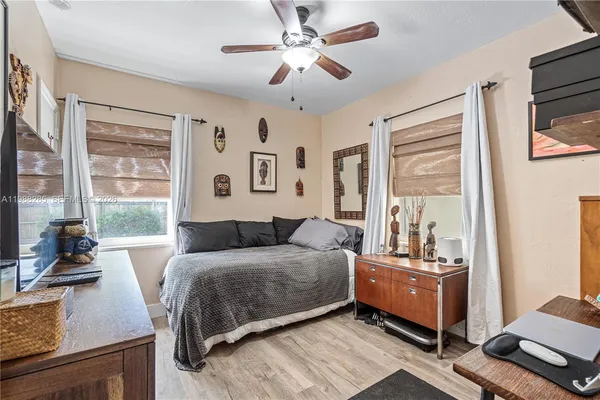 a bedroom with a bed and wooden floor