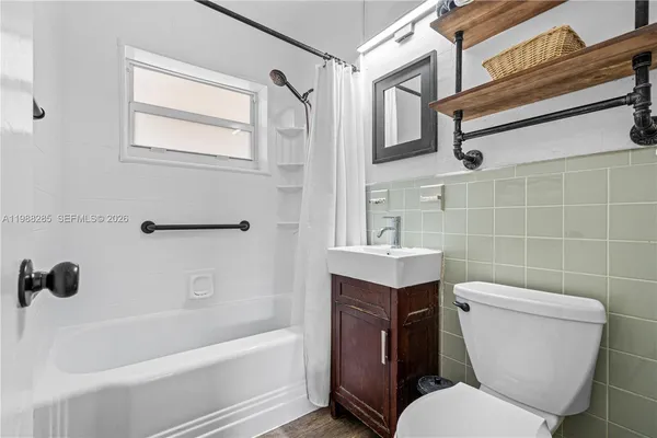 a bathroom with a toilet a sink and bathtub