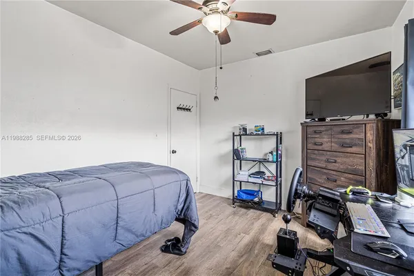 a bedroom with furniture and a flat screen tv