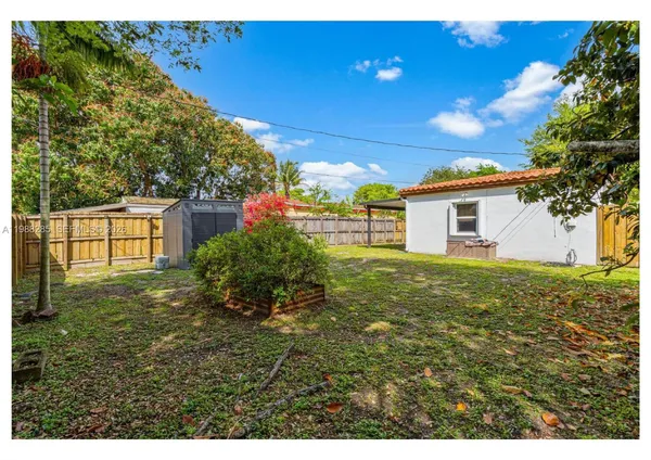 a view of a backyard with plants and a backyard
