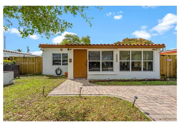 a view of a house with backyard porch and sitting area
